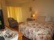 Charming bedroom with warm lighting, laminate floors, and a comfortable seating area at 4057 Crockers Lake Blvd # 15, Sarasota, FL 34238