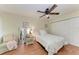 Bright bedroom features a ceiling fan, ample natural light, and comfortable furnishings, including a floral bedspread at 4057 Crockers Lake Blvd # 15, Sarasota, FL 34238