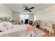 Bright bedroom features a ceiling fan, ample natural light, and comfortable furnishings with some furniture at 4057 Crockers Lake Blvd # 15, Sarasota, FL 34238