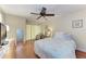 Cozy bedroom features natural light and comfortable floral bedding; also includes a doorway at 4057 Crockers Lake Blvd # 15, Sarasota, FL 34238
