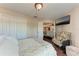 Cozy bedroom with wood floors, walk-in closet, and a flatscreen TV above a floral armchair at 4057 Crockers Lake Blvd # 15, Sarasota, FL 34238
