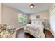 Comfortable bedroom featuring natural light and a floral patterned bedspread, plus view of the window at 4057 Crockers Lake Blvd # 15, Sarasota, FL 34238