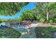 Bike rack area surrounded by lush greenery and paved walkways, providing convenient storage for residents' bicycles at 4057 Crockers Lake Blvd # 15, Sarasota, FL 34238