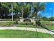 Community entrance sign amid tropical landscaping, showcasing community name and established date at 4057 Crockers Lake Blvd # 15, Sarasota, FL 34238