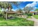 Outdoor community grill and picnic area with covered tables and green space, perfect for gatherings at 4057 Crockers Lake Blvd # 15, Sarasota, FL 34238