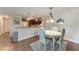 Dining area with modern chandelier lighting with view of the kitchen and stainless steel appliances at 4057 Crockers Lake Blvd # 15, Sarasota, FL 34238