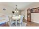 Bright dining room with elegant chandelier and wooden floors, perfect for Gathering meals at 4057 Crockers Lake Blvd # 15, Sarasota, FL 34238