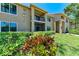 Beautiful two-story condo building with manicured landscaping and inviting outdoor spaces and balcony at 4057 Crockers Lake Blvd # 15, Sarasota, FL 34238