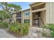 Tan condo building with a combination of screened balconies and stairwell access for upper levels at 4057 Crockers Lake Blvd # 15, Sarasota, FL 34238