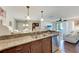 Open kitchen has granite countertops, stainless steel appliances, and a view into the living room at 4057 Crockers Lake Blvd # 15, Sarasota, FL 34238