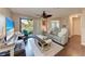 Bright living room features a comfortable seating area and a sliding glass door to outdoor space at 4057 Crockers Lake Blvd # 15, Sarasota, FL 34238