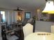 Open living room with neutral tones, slider to balcony and view of the dining area at 4057 Crockers Lake Blvd # 15, Sarasota, FL 34238