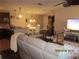 Living space with kitchen, dining area and living room with large TV at 4057 Crockers Lake Blvd # 15, Sarasota, FL 34238
