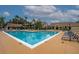 Resort-style community pool with ample seating, lush landscaping, and inviting clear blue water at 4057 Crockers Lake Blvd # 15, Sarasota, FL 34238