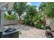 Secluded brick patio featuring lush landscaping and mature trees, providing ample shade at 412 E Amelia Ave, Tampa, FL 33602