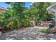 Private backyard oasis with brick pavers, tropical foliage, and lush greenery at 412 E Amelia Ave, Tampa, FL 33602