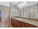 Bathroom featuring a granite countertop, dark wood vanity, and glass-enclosed shower at 412 E Amelia Ave, Tampa, FL 33602