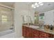 Bathroom with a shower and bathtub combo, granite countertop, and framed mirror at 412 E Amelia Ave, Tampa, FL 33602
