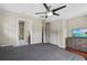 Spacious bedroom with a ceiling fan, closet, and view of a bathroom at 412 E Amelia Ave, Tampa, FL 33602