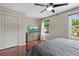 Cozy bedroom featuring a ceiling fan, modern dresser, and beautiful hardwood floors at 412 E Amelia Ave, Tampa, FL 33602