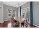 Bright dining area with wood table, transom windows and drapes offers style and light at 412 E Amelia Ave, Tampa, FL 33602