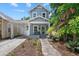 Charming two-story home with a covered porch and a well-manicured front yard, offering great curb appeal at 412 E Amelia Ave, Tampa, FL 33602