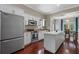 Modern kitchen featuring stainless steel appliances, white cabinetry, and a central island at 412 E Amelia Ave, Tampa, FL 33602