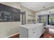 Kitchen with white cabinets, an island, and a chalkboard accent wall adds charm at 412 E Amelia Ave, Tampa, FL 33602