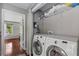 Convenient laundry area with a washer, dryer, and storage shelves at 412 E Amelia Ave, Tampa, FL 33602