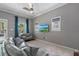 Bright living room with hardwood floors, a cozy couch, and a ceiling fan at 412 E Amelia Ave, Tampa, FL 33602