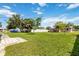 Large open backyard with mature trees, fencing, and a home's exterior in view at 417 Glen Oak Rd, Venice, FL 34293