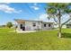 Exterior rear view showing the lawn and access to the back entrance at 417 Glen Oak Rd, Venice, FL 34293