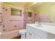 Bathroom with a tub and shower combination, a white sink vanity, and a large mirror at 417 Glen Oak Rd, Venice, FL 34293