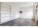 Bedroom featuring a built-in shelving unit, window and the potential for updates at 417 Glen Oak Rd, Venice, FL 34293