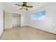 Unfurnished bedroom with neutral walls, tile flooring, a ceiling fan, a closet, and a window at 417 Glen Oak Rd, Venice, FL 34293