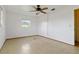 Simple bedroom features neutral walls, tile flooring, a ceiling fan, and a closet at 417 Glen Oak Rd, Venice, FL 34293