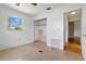 A bedroom featuring an empty closet, window to outside, and a doorway with hardwood flooring visible in the hall at 417 Glen Oak Rd, Venice, FL 34293