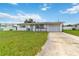 Inviting single-story home with a front lawn and private driveway leading to an attached garage at 417 Glen Oak Rd, Venice, FL 34293