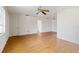 Open-concept living room features wood-look flooring, a ceiling fan, and neutral walls at 417 Glen Oak Rd, Venice, FL 34293