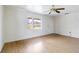 Bright living room with wood-look flooring, a ceiling fan, and a large window at 417 Glen Oak Rd, Venice, FL 34293