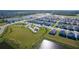 Aerial view of a new neighborhood featuring modern homes, a playground, and ponds at 4515 Boxelder Avenue, Parrish, FL 34219