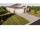 Attractive single-story home boasts a two-car garage, manicured lawn, and spacious driveway at 4515 Boxelder Avenue, Parrish, FL 34219