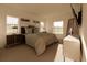 Bright main bedroom with a large bed, carpet, a TV, and bedside tables at 4515 Boxelder Avenue, Parrish, FL 34219