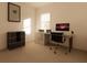 Bright home office with large window, modern desk with computer, and storage shelves provides space to work from home at 4515 Boxelder Avenue, Parrish, FL 34219