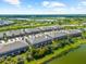 Property aerial view showing a pond, greenbelts, and neatly arranged homes in a planned community at 4644 Vignette Way, Sarasota, FL 34240