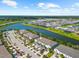 Aerial view of a stunning waterfront community with lush landscaping and beautiful homes along the water at 4644 Vignette Way, Sarasota, FL 34240