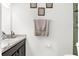 Clean powder room featuring a vanity with granite countertop, wall art, and neutral towels at 4644 Vignette Way, Sarasota, FL 34240