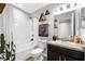 Bright bathroom features a shower/tub combination and updated vanity at 4644 Vignette Way, Sarasota, FL 34240