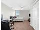 Bedroom with carpet flooring and a ceiling fan. Includes a desk, TV, and closet at 4644 Vignette Way, Sarasota, FL 34240