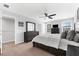 Bedroom featuring neutral colors, a ceiling fan, and a large mirror at 4644 Vignette Way, Sarasota, FL 34240